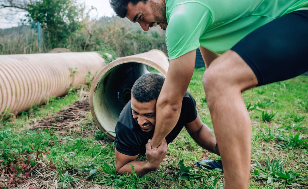 Participants obstacle course going through a pipe